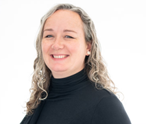 Head-and-shoulders portrait of a person with long, curly gray hair wearing a black turtleneck against a white background.